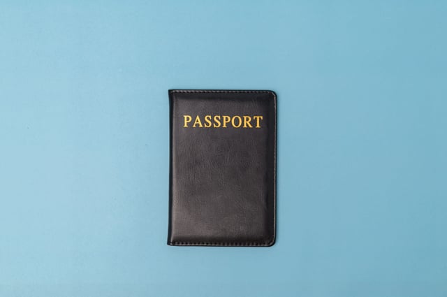 A Passport Against A Blue Background