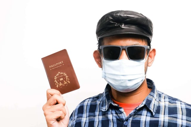A Picture Of Men Playing As Tourist Wearing Face Mask
