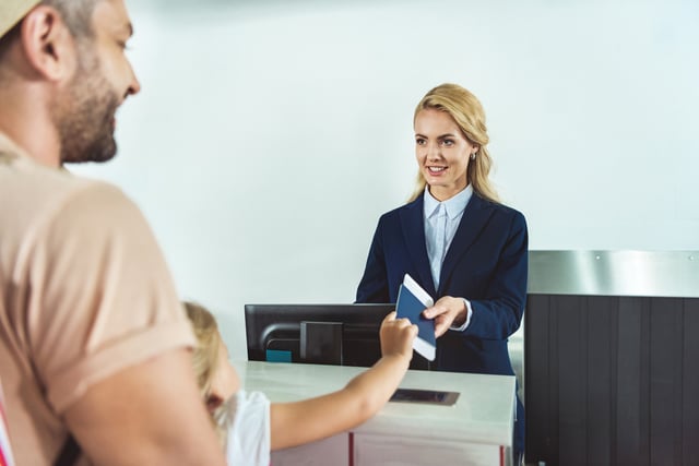 Giving A Passport To The Immigration Counter