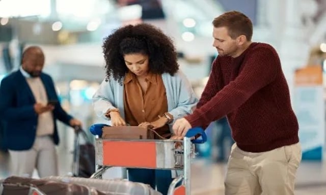 Passenger Checking In At Airport