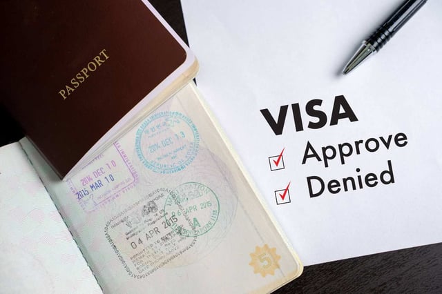 Visa And Passport To Approved Stamped On A Document