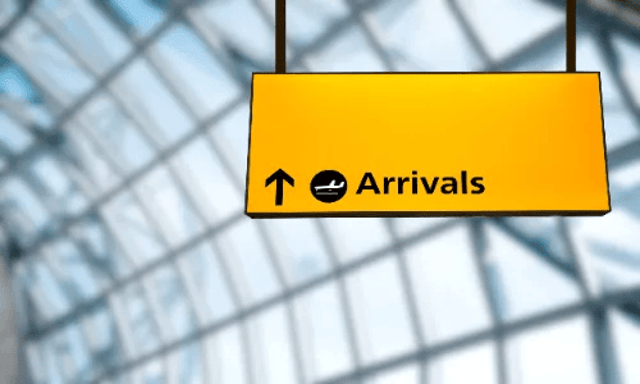 Yellow Airport Arrivals Sign With Arrow