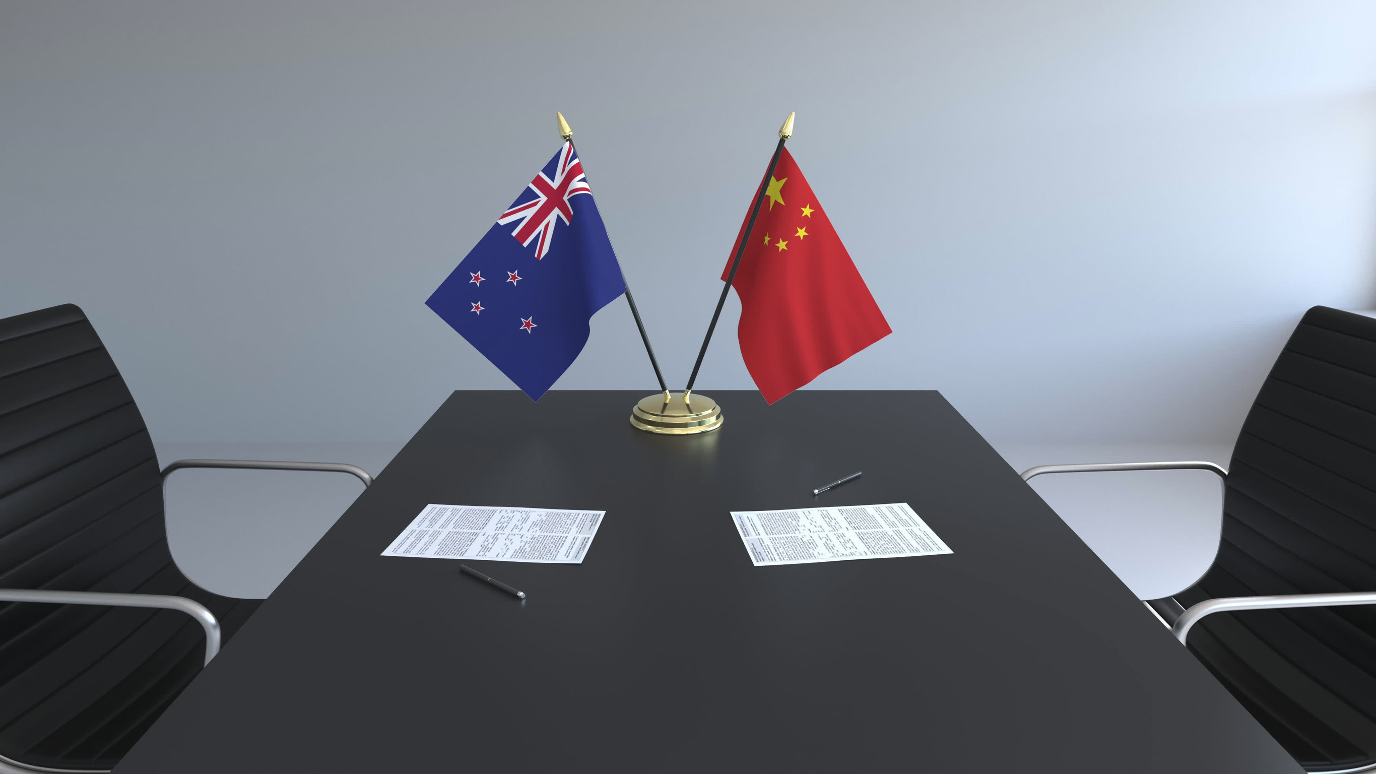 New Zealand And China Flags On Table