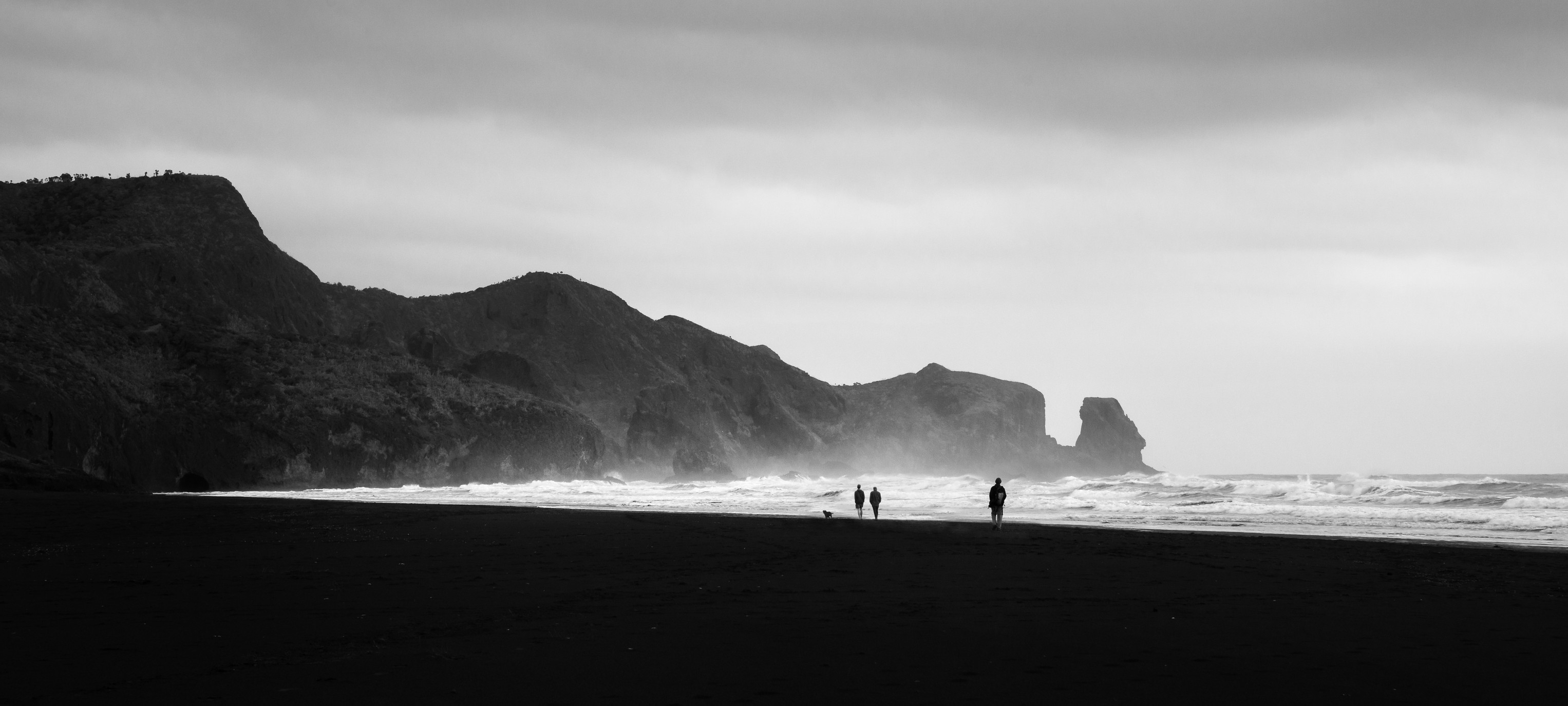 People Walking On Bethells Beach West Auckland New Zealand